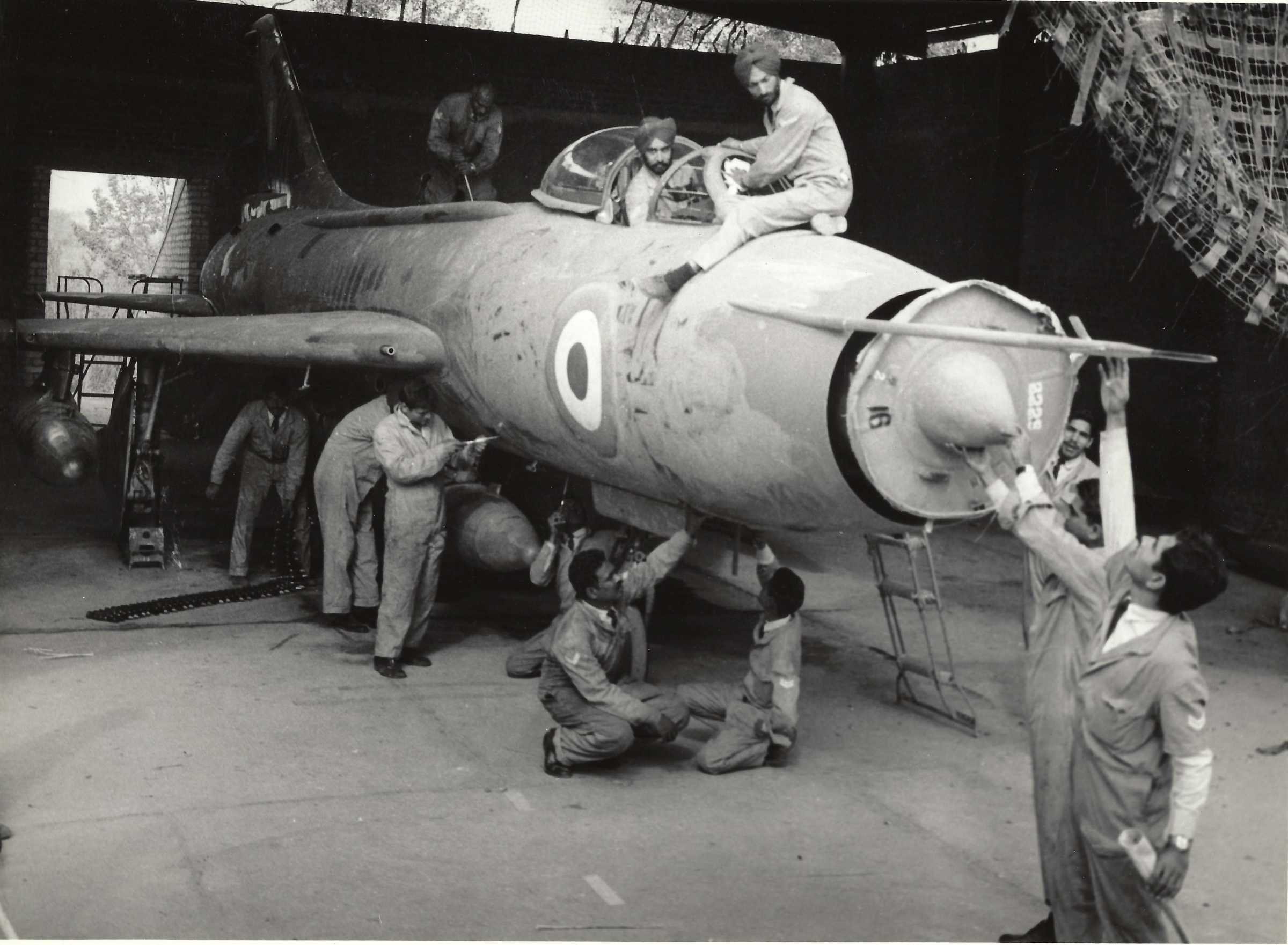 airmen technicians working on a Su 7 (1) low